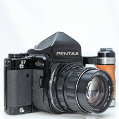 Pentax 67 SLR mirror up film camera w/Super -multi-coated Takumar 105mm f2.4 lens, and handle