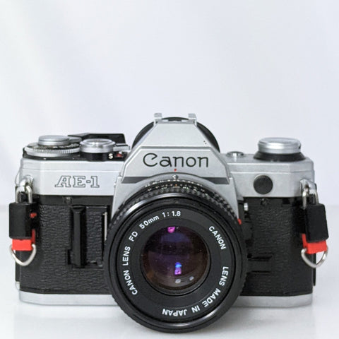 Canon AE-1 35mm film SLR camera w/ 50mm f1.8 Canon FD lens. MINT